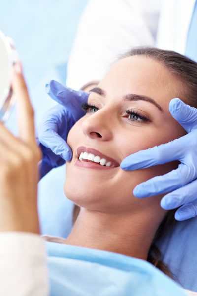 Picture of adult woman having a visit at the dentist's