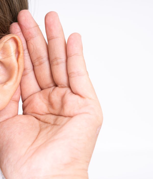 woman hearing loss or hard of hearing and cupping her hand behind her ear isolate on white background, Deaf concept.